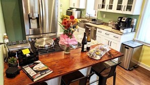 A kitchen with a wooden island, stainless steel appliances, and white cabinets. - Walkable Elmwood Cottage, No Chores 2Bath 2BR 1Car (Buffalo)