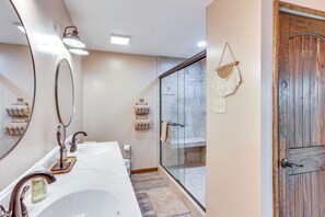 A bathroom with two sinks, a glass shower enclosure, and a wooden door. - 'the Duck Farm' Sugar Tree Hideaway w/ Yard! (Sugar Tree)