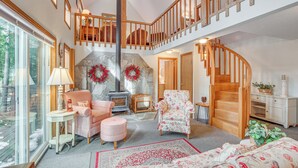 A spacious living room with a fireplace, a staircase, and a cozy seating area. - Washington Mountain Cabin: 1 Mi to Lake Cle Elum (Cle Elum)