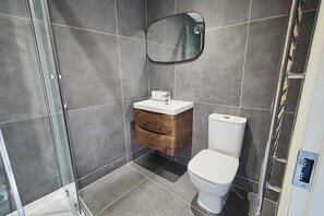 Shower, hair dryer, towels, shampoo