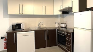 Eine moderne Küche mit Geschirrspüler, Mikrowelle, Toaster und Backofen.