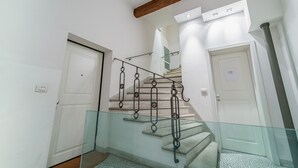 Eine Treppe mit Glasgeländern und einer Decke aus Holzbalken.