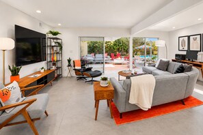 A modern living room with a grey sofa, wooden coffee table, and a TV on the wall. - 25% Off Oct 29-31 Perfect 4 Families Pool, Jacuzzi (Palm Springs)
