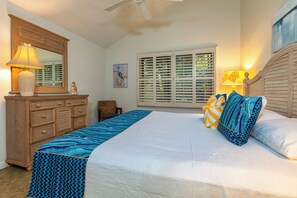 A bedroom with a bed, dresser, and window with blinds. - Ma'alaea Surf #G-1 – Ground Floor Gem with Modern Comfort (Kihei, Maui)