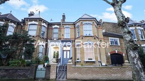 A Victorian-style townhouse with a prominent bay window, a front door, and a brick facade. - Hackney Suites - Single Room! (Greater London)