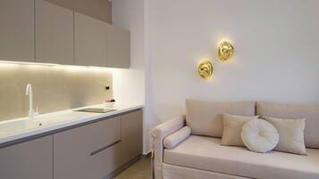 One Bedroom Suite with Sea View | Living area | 32-inch flat-screen TV with satellite channels