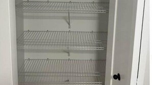 A white interior with three wire shelves. - A Home away from Home
 (Dieppe)