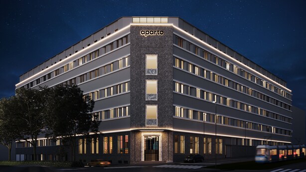 A modern multi-story hotel with a prominent entrance and illuminated signage. - aparto Milan Ripamonti (Milan)