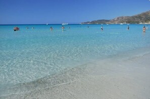 A beach with clear turquoise water and a sandy shore. - Vacation house Campulongu 150 mt from the sea "Villa Carolina" (Villasimius)