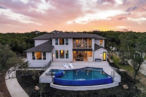 A two-story house with a swimming pool and a patio. - Scenic Hollows Escape with Trails & Outdoor Fun (Jonestown)
