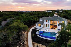 A two-story house with a swimming pool, surrounded by dense vegetation. - Scenic Hollows Escape with Trails & Outdoor Fun (Jonestown)