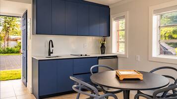 A kitchenette located in the detached backyard suite alongside Bedroom 8.
