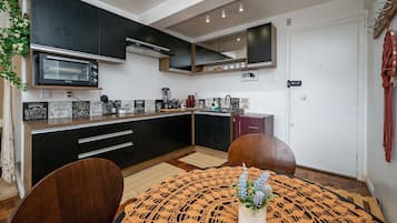 Apartment | Private kitchen | Mini-fridge, microwave, stovetop, cookware/dishes/utensils