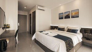 A modern hotel room with a large bed, bedside tables, a desk, and a chair. - La Cozii TK (Phnom Penh)
