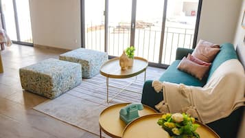 Departamento Deluxe, vista al patio | Área de sala de estar | Smart TV de 65 pulgadas con canales digitales