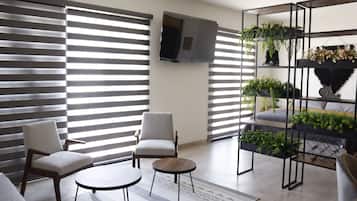 Deluxe Apartment, Courtyard View | Living area | 65-inch Smart TV with digital channels