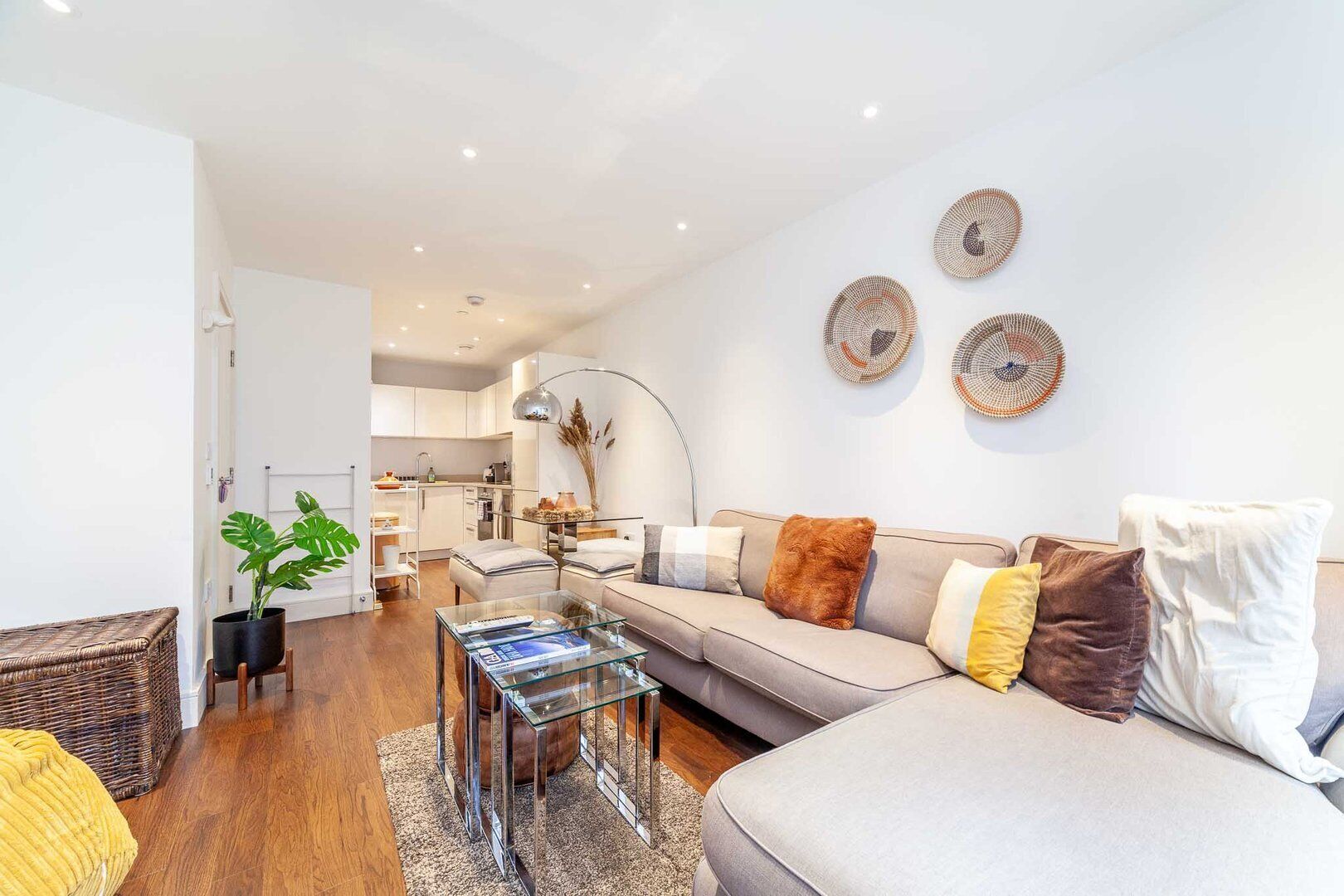 A modern living room with a sofa, coffee table, and decorative wall art.