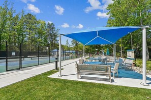 A park with a tennis court, seating area, and playground. - Lakefront Sea Colony Villa! Amenity Rich with Private Beach and Shuttle! (Bethany Beach)