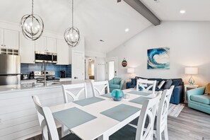 A modern kitchen with a central island, white cabinetry, and stainless steel appliances. - Lakefront Sea Colony Villa! Amenity Rich with Private Beach and Shuttle! (Bethany Beach)