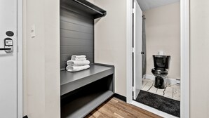 Un baño moderno con tocador gris, inodoro y zona de ducha.