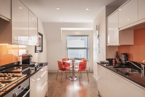 Enjoy meals and socializing around the central island with a round table and four chairs.
