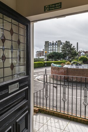 Exit leads to a scenic street view with a roundabout and nearby buildings.