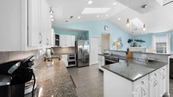 Fridge, microwave, coffee/tea maker, cookware/dishes/utensils