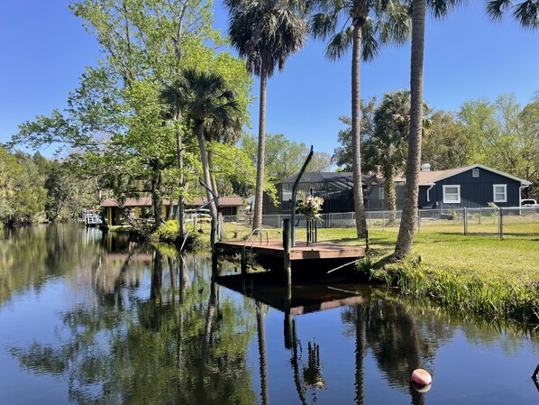 Overlooking the serene lake, this lakeside retreat offers a tranquil atmosphere surrounded by lush greenery and tall palm trees.