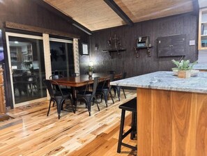 Enjoy meals in this dining area with a large table, comfortable chairs, and a kitchen just steps away.