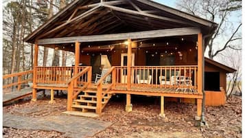 Relax on the covered porch with comfortable seating and take in the serene surroundings.