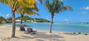 Beach nearby, white sand, sun-loungers, beach towels - Wild Lotus Villa - Waterfront on Jolly Harbour (Jolly Harbour)