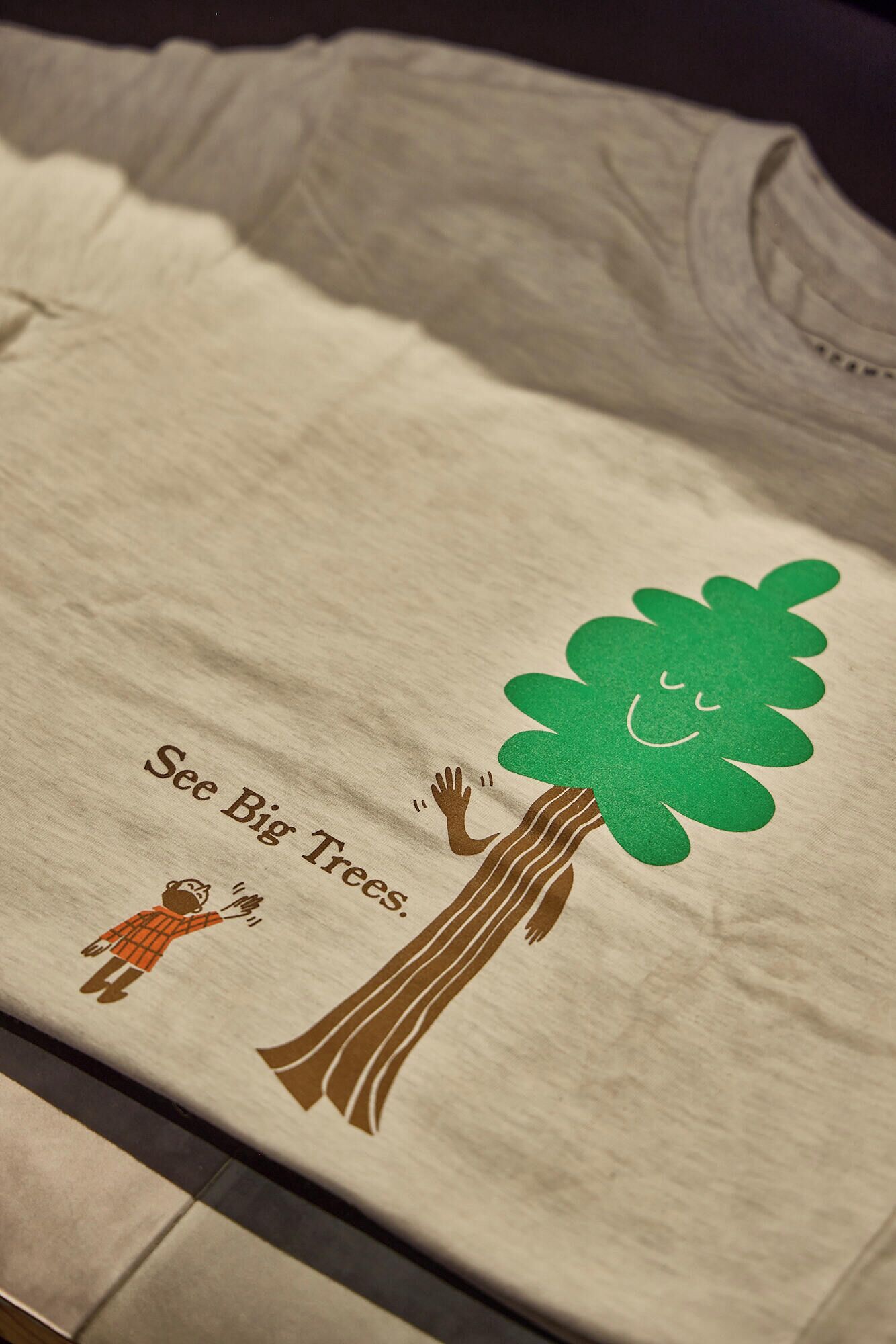 A fabric with a tree and a person.