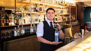 A bar with shelves stocked with various bottles and glasses. - GRAN HOTEL BOLIVAR (Lima)