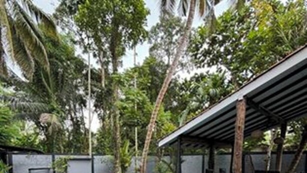 A rectangular swimming pool with a blue mat in the center, surrounded by a stone deck. - Villa Luxury Virginia With Pool and Garden (Gonapinuwala)