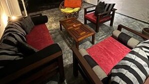 An outdoor seating area with a sofa, chairs, and a table. - Villa Luxury Virginia With Pool and Garden (Gonapinuwala)