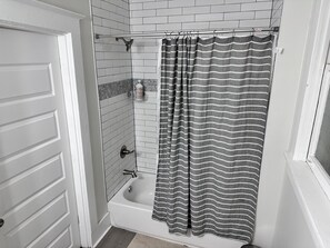 Een douche, handdoeken, zeep, shampoo