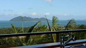 A view from a balcony overlooking a coastal landscape with a mountain and the sea. - Stu’s Lookout - Stunning Views (Wongaling Beach)