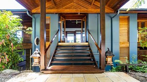 A wooden staircase leading to a covered entrance with a view of the interior. - Stu’s Lookout - Stunning Views (Wongaling Beach)