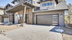 A modern two-story house with a garage, stone exterior, and a covered entryway. - Flagstaff Group Getaway w/ Game Room & Deck (Flagstaff)