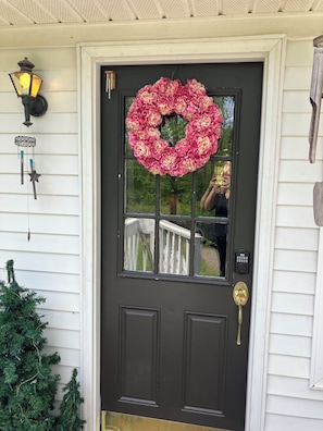Welcome to a charming home with a beautiful floral wreath and a cozy entrance.