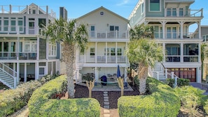 A multi-story beachfront house with balconies, a patio area, and palm trees. - 26 Morgans Cove Drive by Avantstay Unique Marina Location (Isle of Palms)