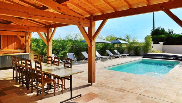 An outdoor pool area with a wooden pergola, lounge chairs, and a dining table with chairs. - Awesome home in Cours De Pile (Cours De Pile)