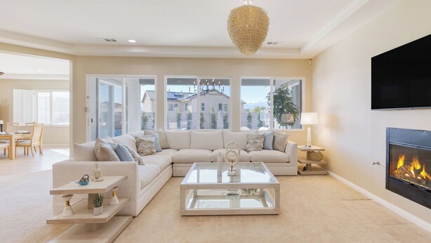 A living room with a sofa, coffee table, and fireplace. - Gated Terra Lago Escape With Private Pool, Hot Tub, Outdoor Kitchen and Lounge (Indio)