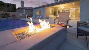 A pool area with a fire feature, outdoor seating, and a covered patio. - Gated Terra Lago Escape With Private Pool, Hot Tub, Outdoor Kitchen and Lounge (Indio)