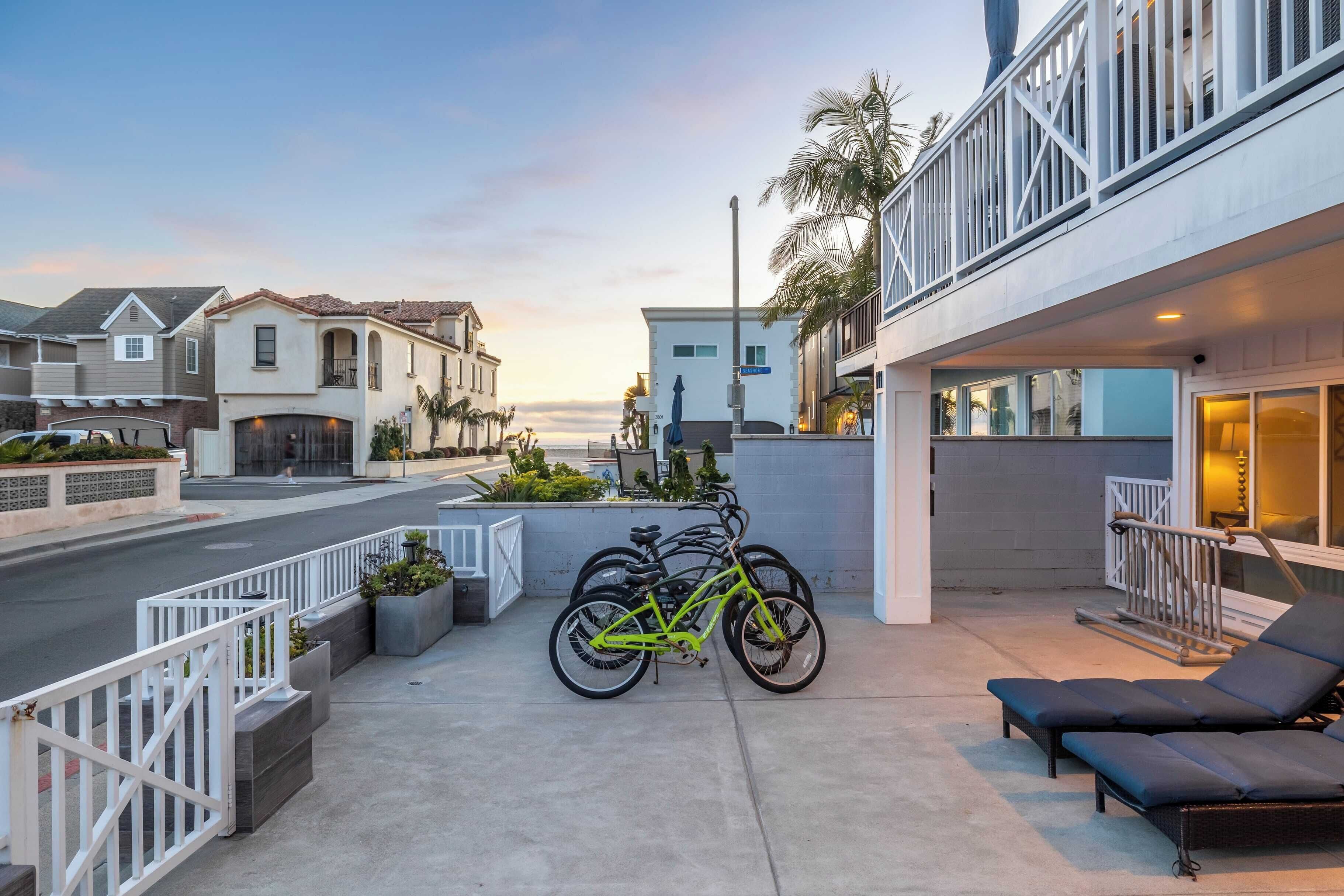 A residential building with a balcony, a bicycle, and a lounge chair.