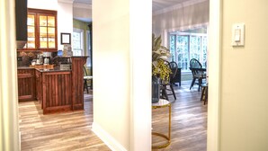 A kitchen with wooden cabinets and a dining area with a table and chairs.