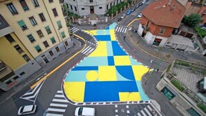 An aerial view of a city intersection with a large, colorful geometric pattern on the road. - Colorful NoLo Studio (Milano)