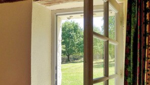A room with a large window revealing a grassy outdoor area and trees. - Beautiful home in Lamonzie Montastruc (Lamonzie Montastruc)