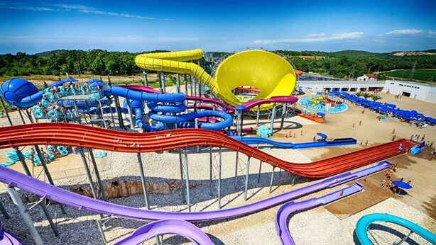 Ein Wasserpark mit mehreren Rutschen und Becken.