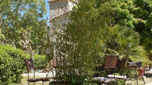 A courtyard with stone walls, a tower, and outdoor seating. - 1 bedroom nice home in Carnas (Carnas)